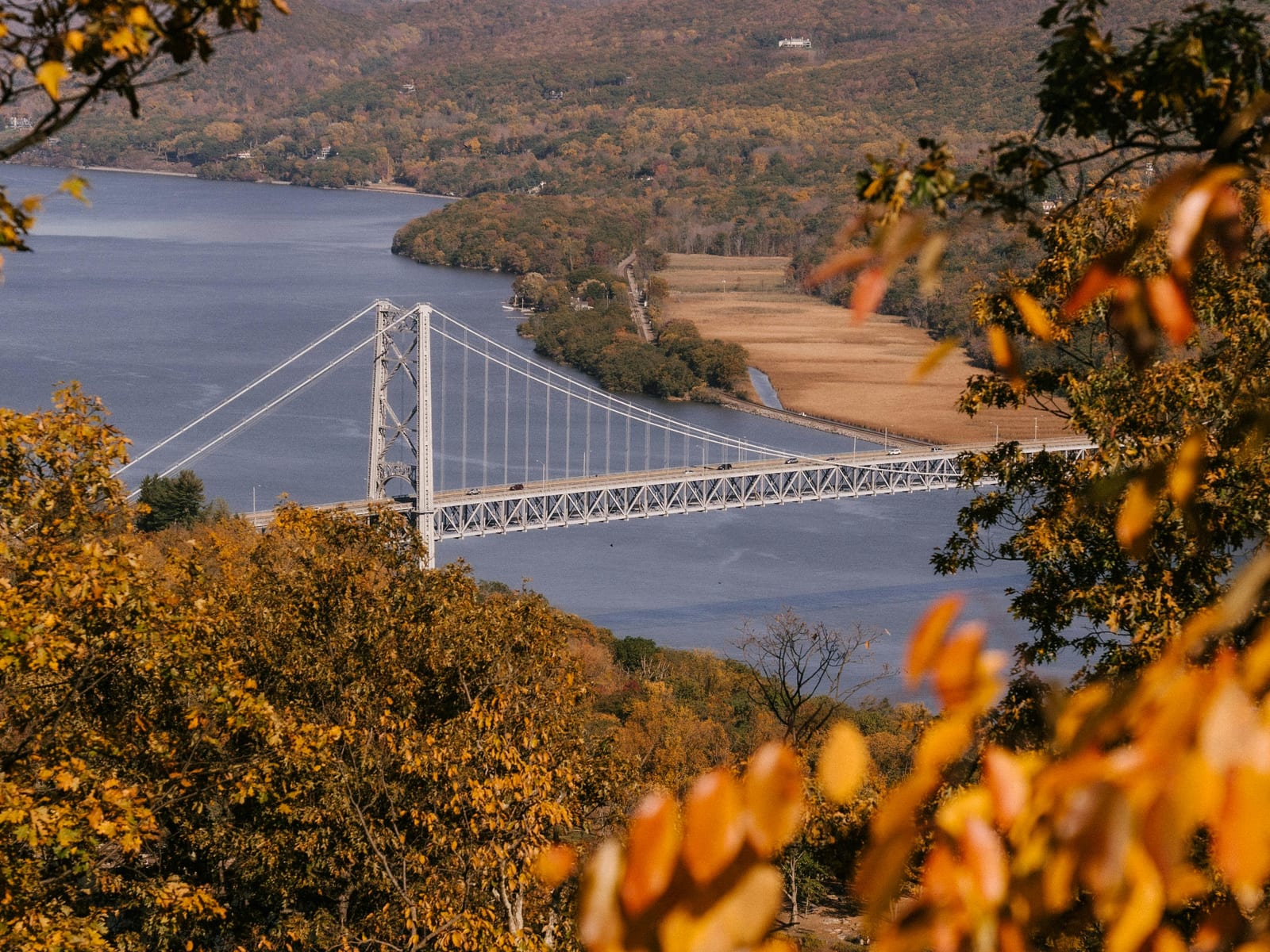 Bear Mountain Bridge and Hudson River framed by autumn foliage